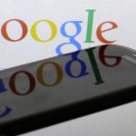 Photo illustration of Google logo is reflected on the screen of a Samsung Galaxy S4 smartphone